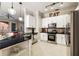 Open kitchen offers white cabinetry, stainless steel appliances, and granite countertops at 3621 Vinings Slope Se # 1231, Atlanta, GA 30339