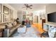 Spacious living room with hardwood floors, a large couch, and balcony access at 3621 Vinings Slope Se # 1231, Atlanta, GA 30339