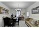 Elegant dining room featuring a chandelier, seating for six, and decorative wall art at 1001 Pine Ridge Dr, Stone Mountain, GA 30087