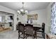 Open dining area with a view into the living room, chandelier, and seating at 1001 Pine Ridge Dr, Stone Mountain, GA 30087