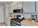 Modern kitchen with stainless steel appliances, gas range, and ample counter space at 1001 Pine Ridge Dr, Stone Mountain, GA 30087