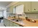 This charming kitchen boasts plenty of cabinet space and a well-lit sink with stainless fixtures at 1001 Pine Ridge Dr, Stone Mountain, GA 30087