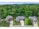 A beautiful single-story brick home in a wooded neighborhood offers manicured landscaping and mature trees at 1610 Turtle Pond Dr, Hoschton, GA 30548