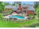 Spacious backyard with a pool, patio, and manicured landscaping at 1610 Turtle Pond Dr, Hoschton, GA 30548