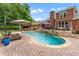 Expansive backyard showcasing an in-ground pool, patio, and lush landscaping at 1610 Turtle Pond Dr, Hoschton, GA 30548