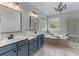 Luxurious bathroom with double vanity, soaking tub, and glass enclosed shower at 1610 Turtle Pond Dr, Hoschton, GA 30548