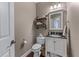 Cozy half-bathroom with toilet, vanity with sink, open shelving at 1610 Turtle Pond Dr, Hoschton, GA 30548
