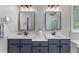 Double vanity bathroom with modern fixtures and ample counter space at 1610 Turtle Pond Dr, Hoschton, GA 30548