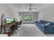 Versatile bedroom can also function as an office with plenty of workspace and a comfortable sofa at 1610 Turtle Pond Dr, Hoschton, GA 30548