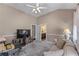 Bedroom and ensuite bathroom showcasing a functional workspace and a relaxing seating area at 1610 Turtle Pond Dr, Hoschton, GA 30548