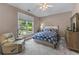 Bright bedroom with a large window, comfortable seating, and stylish furnishings for a cozy feel at 1610 Turtle Pond Dr, Hoschton, GA 30548