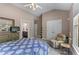 Bedroom with large windows and vaulted ceilings adjacent to an ensuite bathroom and walk-in closet at 1610 Turtle Pond Dr, Hoschton, GA 30548