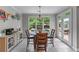 Sunlit breakfast nook features views of private backyard and access to the outdoor patio at 1610 Turtle Pond Dr, Hoschton, GA 30548