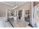 Formal dining area featuring elegant chandelier, wainscoting, and view to adjacent living area at 1610 Turtle Pond Dr, Hoschton, GA 30548