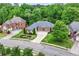 Stunning single-story brick home features an expansive front lawn, mature trees, and an inviting curved driveway at 1610 Turtle Pond Dr, Hoschton, GA 30548