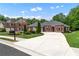 Beautiful brick home featuring a well-manicured lawn, and a large driveway at 1610 Turtle Pond Dr, Hoschton, GA 30548