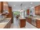 Spacious kitchen with stainless steel appliances, granite countertops and an island with view to breakfast nook at 1610 Turtle Pond Dr, Hoschton, GA 30548