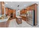 Well-equipped kitchen with stainless steel appliances, granite countertops, and a central island at 1610 Turtle Pond Dr, Hoschton, GA 30548
