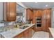 Well-equipped kitchen with stainless steel appliances, granite counters, and wood cabinets at 1610 Turtle Pond Dr, Hoschton, GA 30548