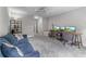Comfortable living room featuring a sofa and desk setup, illuminated by a modern ceiling fan at 1610 Turtle Pond Dr, Hoschton, GA 30548