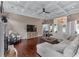 Open-concept living area featuring hardwood floors, coffered ceiling, and ample seating at 1610 Turtle Pond Dr, Hoschton, GA 30548