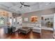 Inviting living room with hardwood flooring, coffered ceiling and a view into the kitchen at 1610 Turtle Pond Dr, Hoschton, GA 30548