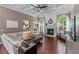 Spacious living room boasts coffered ceilings, fireplace, hardwood floors and lots of natural light at 1610 Turtle Pond Dr, Hoschton, GA 30548