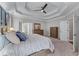 Beautiful main bedroom with tray ceiling and large windows at 1610 Turtle Pond Dr, Hoschton, GA 30548
