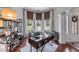 Well-lit home office featuring hardwood floors, a built-in bookshelf, and a desk at 1610 Turtle Pond Dr, Hoschton, GA 30548