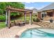 Outdoor lounge area with pergola offering a relaxing space by the pool at 1610 Turtle Pond Dr, Hoschton, GA 30548