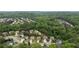 Overhead aerial view of a wooded neighborhood showcasing the houses, yards, and surrounding trees at 1955 Piedmont Cove Ln, Cumming, GA 30040
