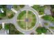 Aerial view of a landscaped neighborhood roundabout surrounded by beautiful homes at 1955 Piedmont Cove Ln, Cumming, GA 30040