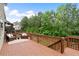 Spacious wooden back deck with wooden railings and outdoor seating overlooking the backyard at 1955 Piedmont Cove Ln, Cumming, GA 30040