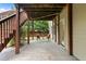 Covered back patio with outdoor seating, a concrete floor, support beams and a door at 1955 Piedmont Cove Ln, Cumming, GA 30040