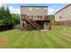 Spacious backyard featuring a deck, stairs, and lawn at 1955 Piedmont Cove Ln, Cumming, GA 30040