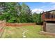Large backyard with a well-maintained lawn, stone path, and tall wooden privacy fence at 1955 Piedmont Cove Ln, Cumming, GA 30040