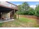 View of a backyard patio with outdoor seating underneath a wooden deck and stairs at 1955 Piedmont Cove Ln, Cumming, GA 30040