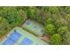 Aerial view of a well-maintained basketball court with trees and a green perimeter at 1955 Piedmont Cove Ln, Cumming, GA 30040