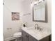 Bathroom featuring marble countertop, gray cabinets, modern lighting, and neutral paint color at 1955 Piedmont Cove Ln, Cumming, GA 30040