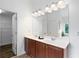 Bright bathroom featuring double sinks, a large mirror and walk-in closet at 1955 Piedmont Cove Ln, Cumming, GA 30040
