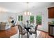 Open dining area with a glass table and chairs, natural light, and hardwood floors at 1955 Piedmont Cove Ln, Cumming, GA 30040