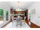 Bright dining area with modern lighting and wood floors, with scenic outdoor views at 1955 Piedmont Cove Ln, Cumming, GA 30040