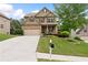 Inviting two-story home with a well-manicured front yard and attached two car garage at 1955 Piedmont Cove Ln, Cumming, GA 30040