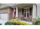 Cozy front porch with stone columns, seating, and decorative plants at 1955 Piedmont Cove Ln, Cumming, GA 30040