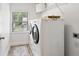 A well-lit laundry room with modern washer and dryer at 1955 Piedmont Cove Ln, Cumming, GA 30040