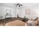 Open living room with hardwood floors, neutral colors, ceiling fan, and decor at 1955 Piedmont Cove Ln, Cumming, GA 30040