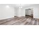 Spacious living room featuring hardwood floors, white walls, and modern recessed lighting at 1955 Piedmont Cove Ln, Cumming, GA 30040