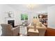 Living room with a cozy fireplace, modern lighting fixture and decorative furniture at 1955 Piedmont Cove Ln, Cumming, GA 30040