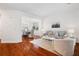 Open-concept living room with hardwood floors and access to the dining room at 1955 Piedmont Cove Ln, Cumming, GA 30040