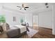 Bedroom featuring hardwood floors, tray ceiling, recessed lighting, and sitting area at 1955 Piedmont Cove Ln, Cumming, GA 30040